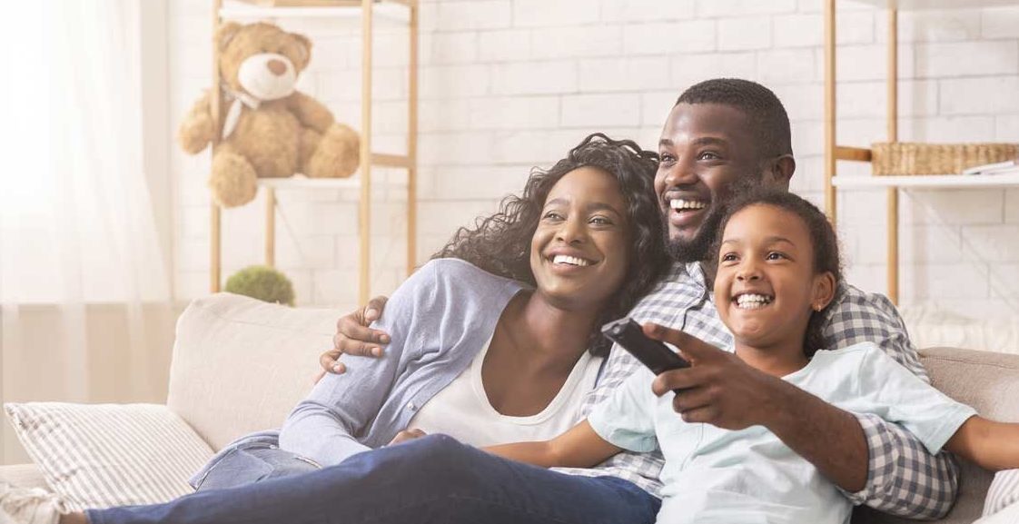 A family enjoying watching TV